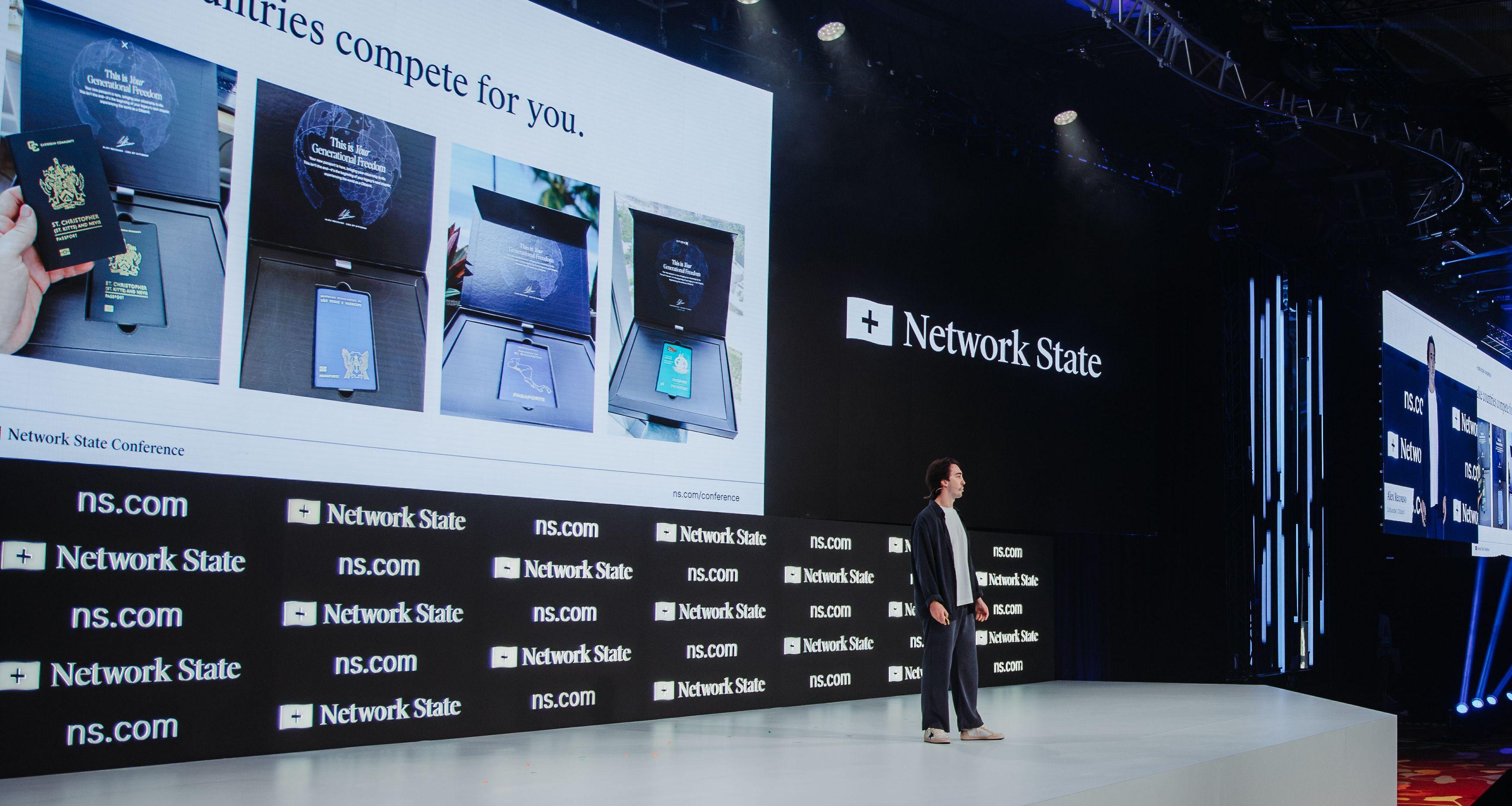 A person presents on stage with a screen displaying "Network State" and product packaging examples.