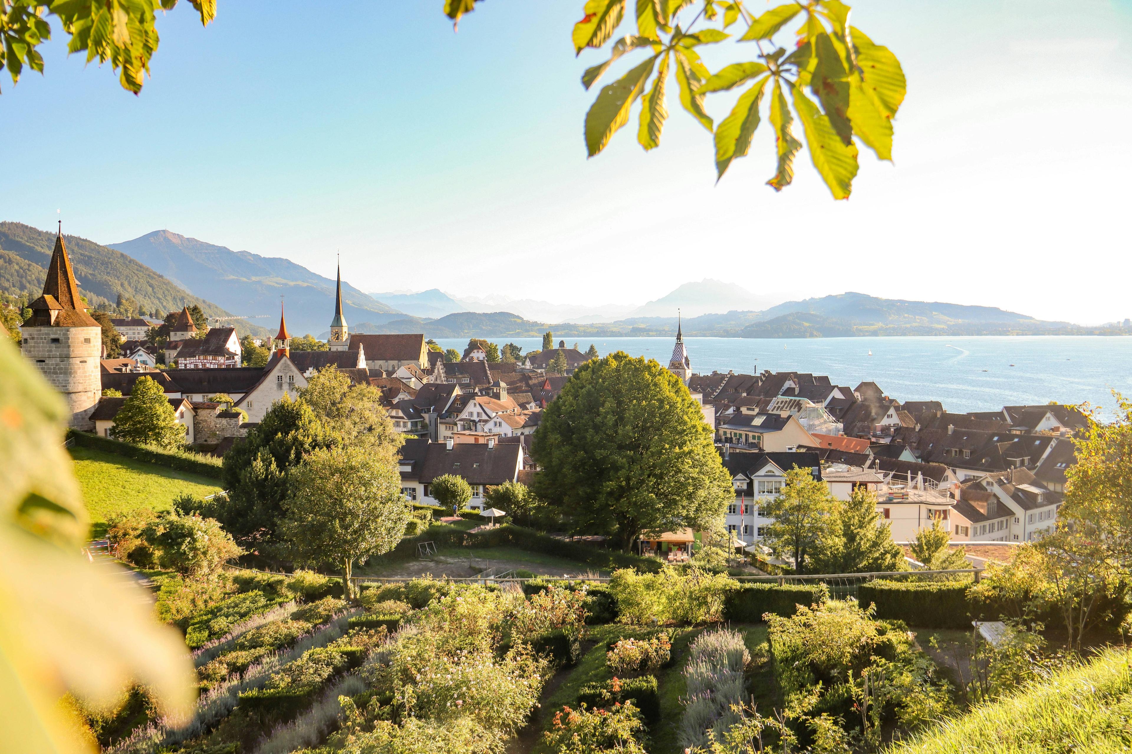 European town with red roofs overlooking a lake in Zug, Switzerland